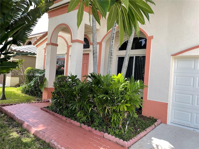 view of exterior entry with a garage