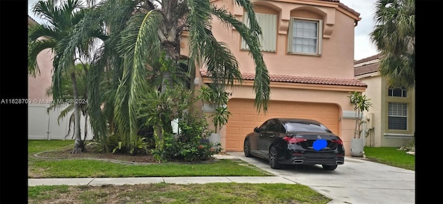 view of front of house featuring a front lawn and a garage