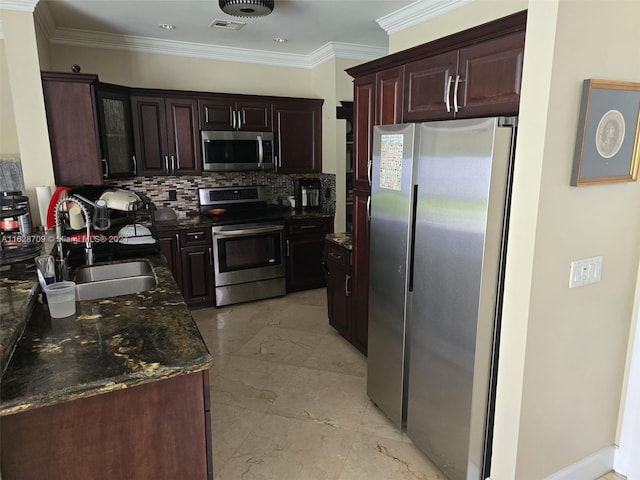 kitchen with appliances with stainless steel finishes, tasteful backsplash, dark stone countertops, sink, and ornamental molding