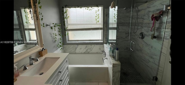 bathroom featuring tile patterned flooring, vanity, independent shower and bath, and a wealth of natural light