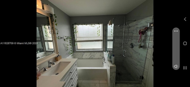 bathroom featuring vanity and plus walk in shower