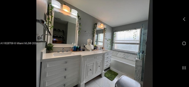 bathroom featuring vanity, tile patterned flooring, and a washtub