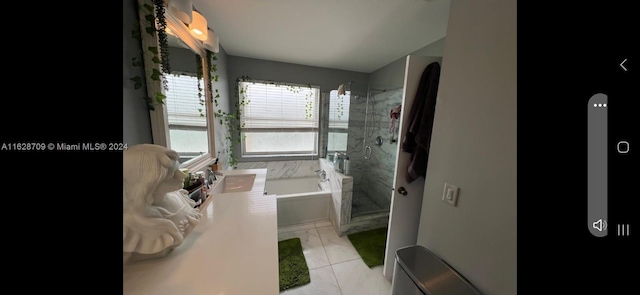 bathroom featuring sink, tile patterned flooring, and shower with separate bathtub