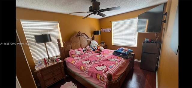 bedroom featuring ceiling fan, a textured ceiling, dark hardwood / wood-style floors, and refrigerator