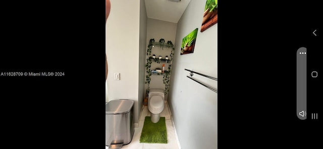 bathroom featuring toilet and tile patterned flooring