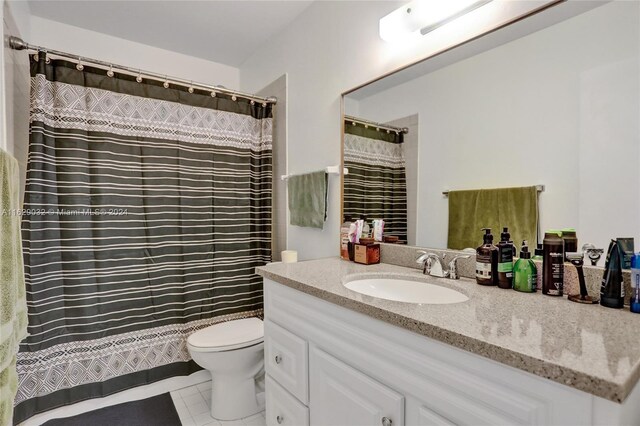 bathroom with tile patterned flooring, vanity, and toilet