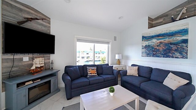 tiled living room featuring lofted ceiling