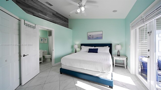 bedroom featuring ceiling fan, light tile patterned flooring, access to outside, and ensuite bath