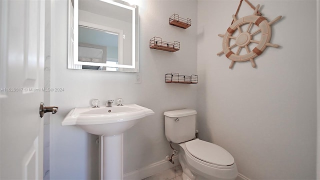 bathroom featuring tile patterned floors, sink, and toilet