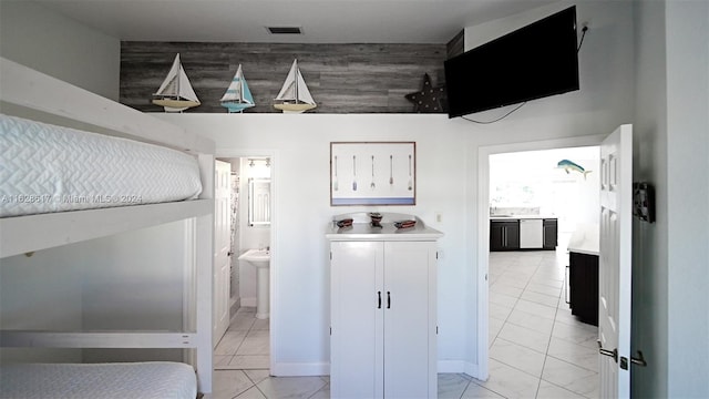 interior space featuring sink and light tile patterned floors