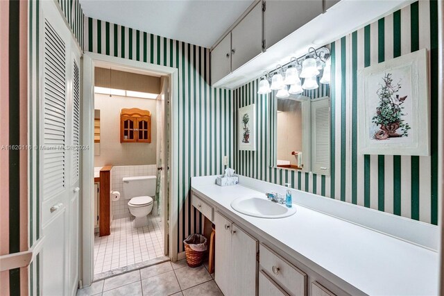 bathroom with tile patterned floors, toilet, and vanity