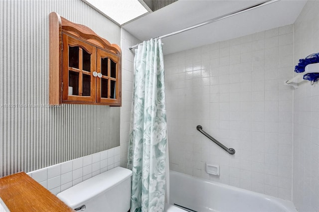 bathroom with shower / bath combination with curtain and toilet