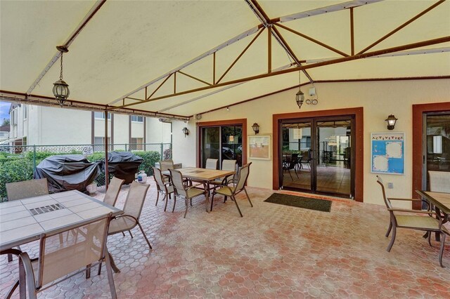 sunroom featuring vaulted ceiling and french doors