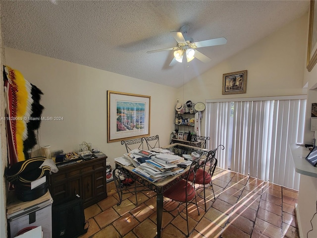 dining room featuring vaulted ceiling, ceiling fan, tile patterned floors, and a textured ceiling