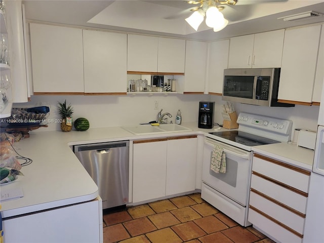 kitchen featuring sink, white cabinets, and appliances with stainless steel finishes