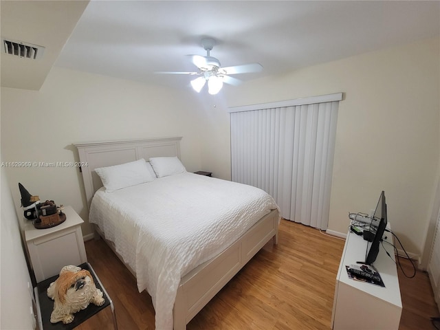 bedroom with light hardwood / wood-style flooring and ceiling fan