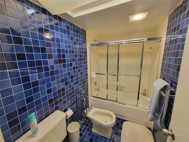 bathroom featuring shower / bath combination with glass door, tile patterned flooring, tile walls, toilet, and a bidet