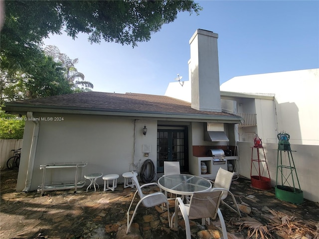 rear view of property with french doors