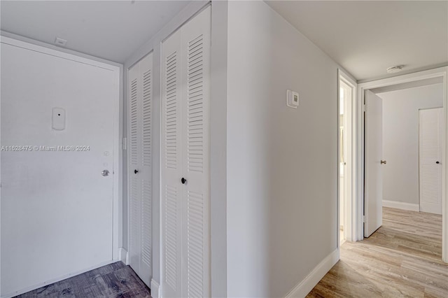 hallway with wood-type flooring