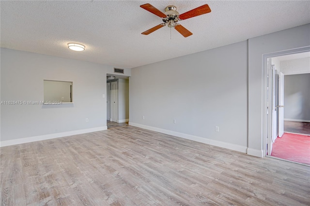 unfurnished room with ceiling fan, a textured ceiling, and light hardwood / wood-style floors