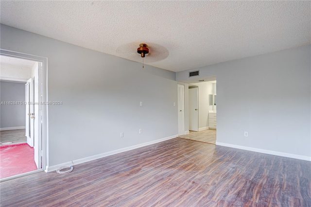 carpeted spare room with a textured ceiling