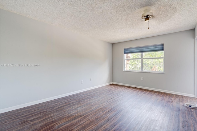 spare room with hardwood / wood-style flooring and a textured ceiling