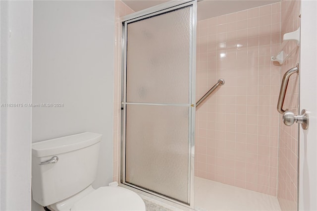 bathroom with walk in shower and toilet