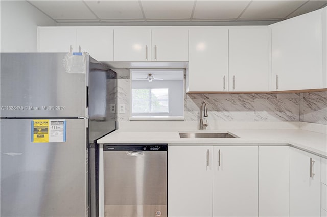 kitchen with sink, stainless steel appliances, white cabinetry, and tasteful backsplash