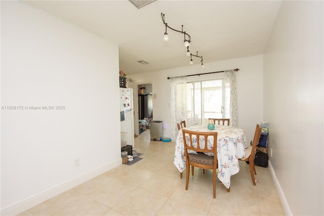 dining space featuring light tile patterned floors