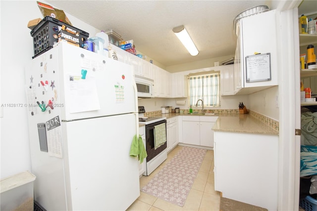 kitchen featuring a textured ceiling, white cabinets, white appliances, and light tile patterned floors