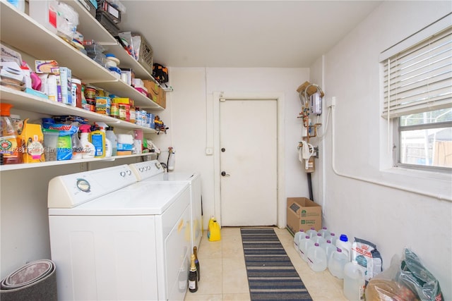 laundry room with washer and dryer and light tile patterned floors