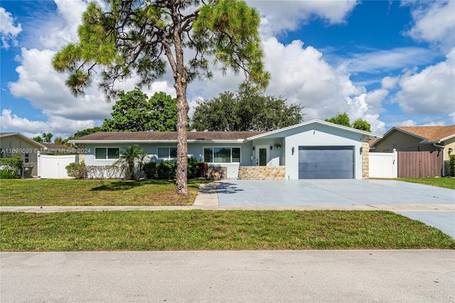 single story home featuring a garage and a front yard