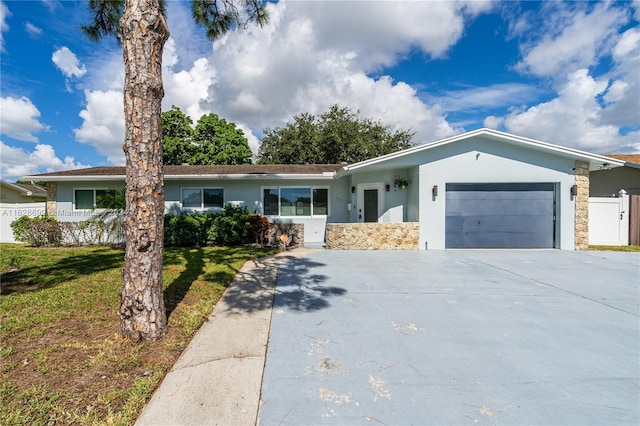 ranch-style house featuring a garage and a front yard