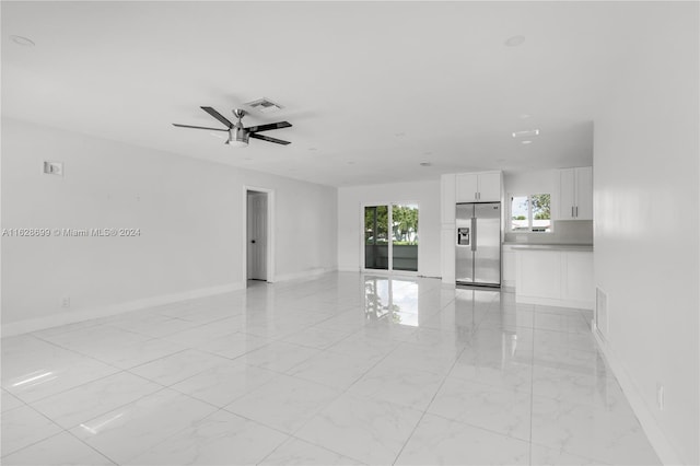 interior space with ceiling fan