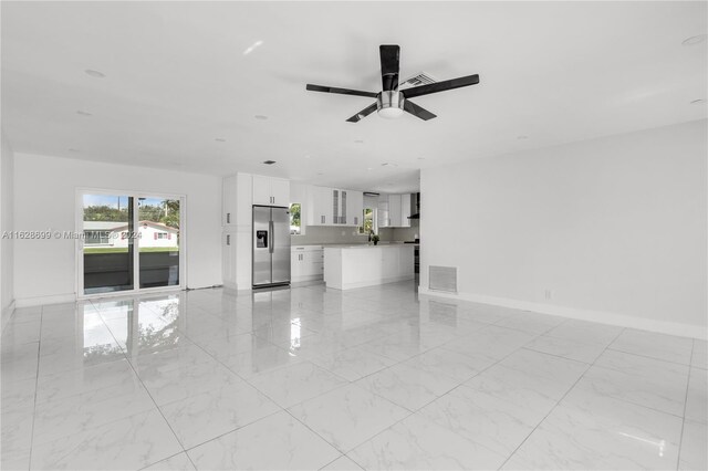 551 NW 42nd Ave, Coconut Creek, FL 33066 - unfurnished living room with baseboards, visible vents, marble finish floor, and ceiling fan