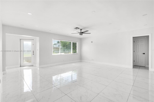 551 NW 42nd Ave, Coconut Creek, FL 33066 - spare room with visible vents, a ceiling fan, baseboards, and marble finish floor