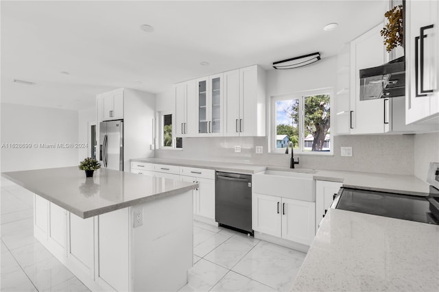 kitchen with light stone countertops, tasteful backsplash, stainless steel appliances, and white cabinetry