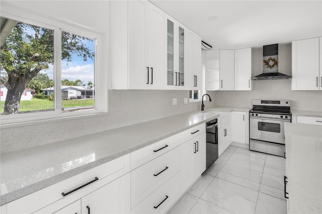 kitchen with wall chimney range hood, black dishwasher, white cabinetry, and stainless steel gas range oven