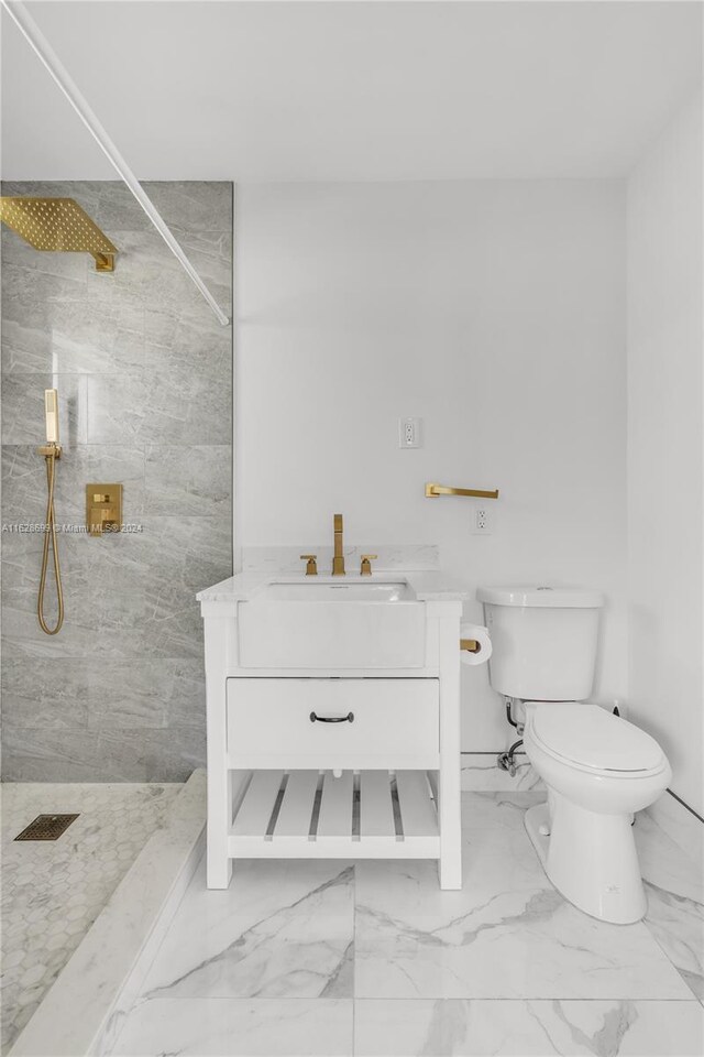 551 NW 42nd Ave, Coconut Creek, FL 33066 - full bathroom featuring toilet, marble finish floor, vanity, and a walk in shower