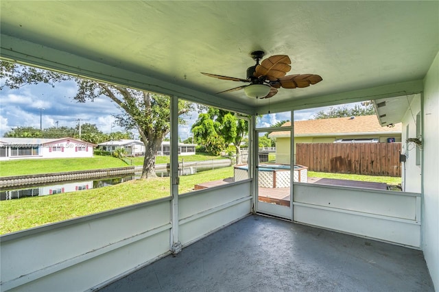 unfurnished sunroom with ceiling fan