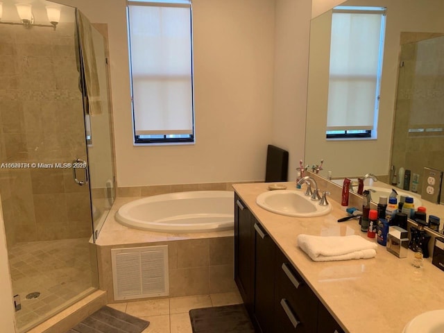 bathroom with a sink, visible vents, tile patterned flooring, a shower stall, and a garden tub