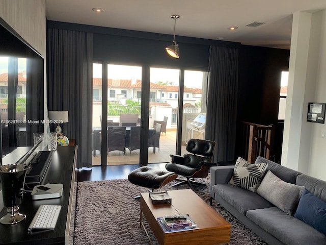 living area featuring wood finished floors and visible vents