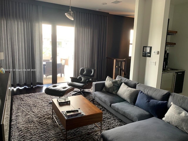 living area featuring wood finished floors and visible vents