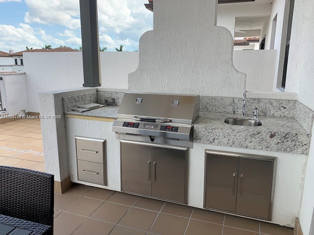 view of patio featuring grilling area, exterior kitchen, and a sink