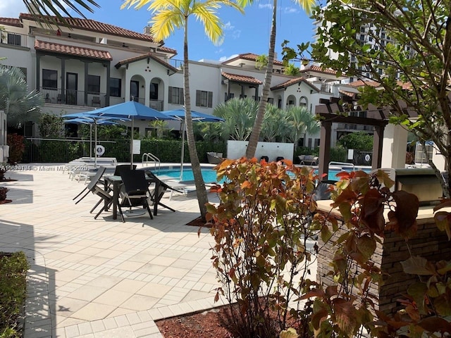 pool featuring a patio area and a pergola