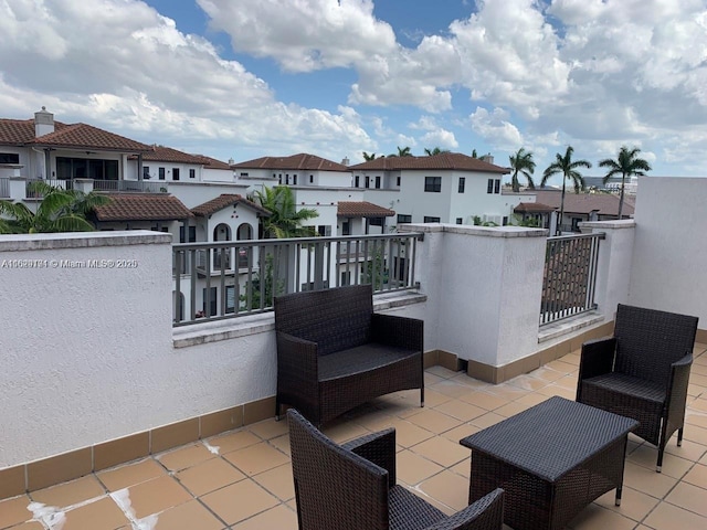view of patio / terrace with a balcony and a residential view