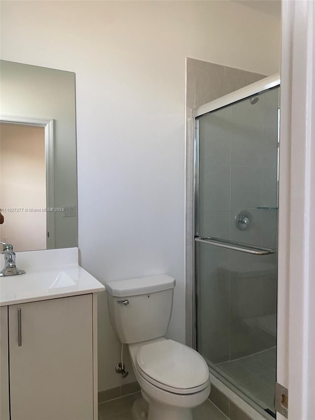 bathroom with vanity, toilet, and walk in shower