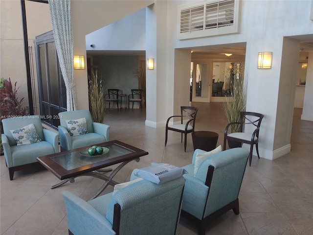 living room featuring light tile patterned flooring and a high ceiling