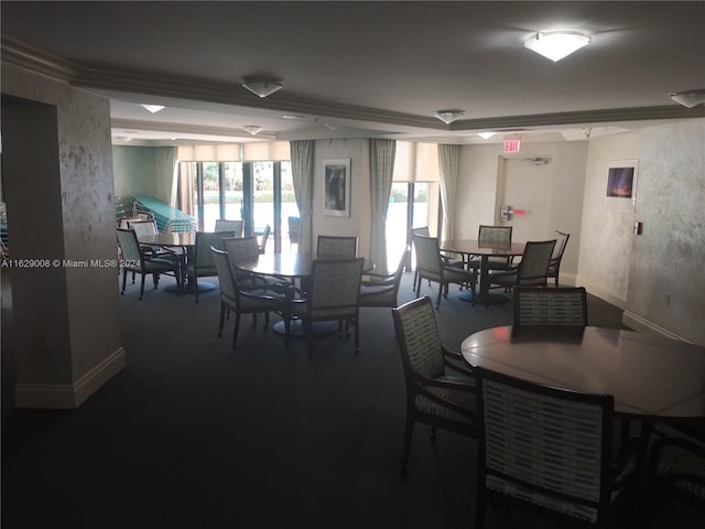 carpeted dining space with ornamental molding