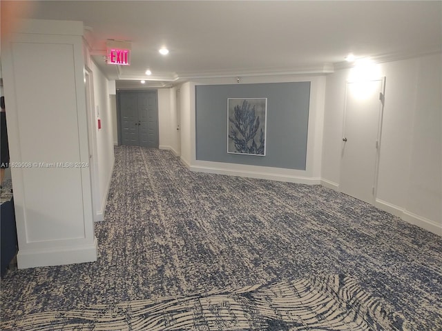 interior space with ornamental molding and carpet flooring